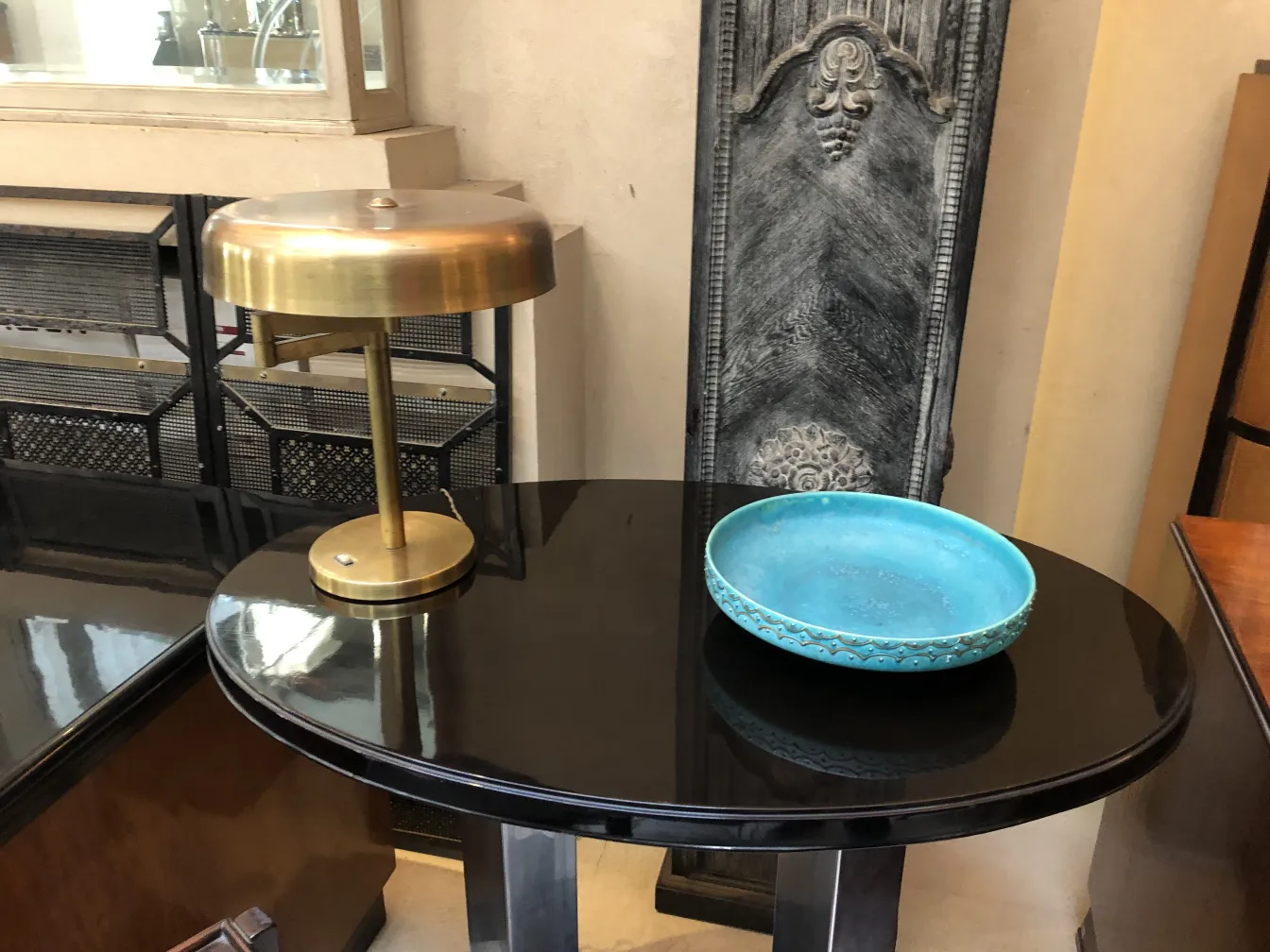 Antique table lamps with elegant design on black table and blue plate