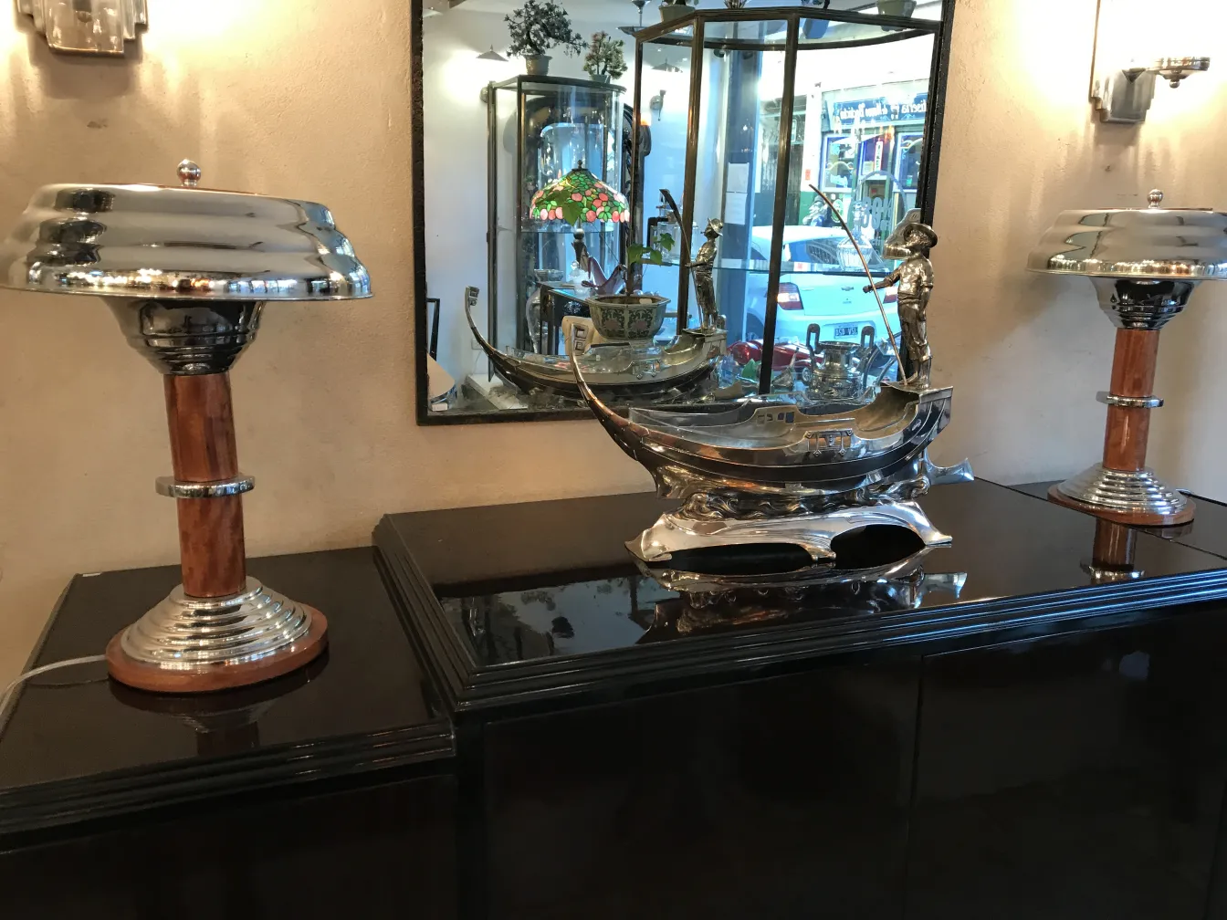 two antique and shiny table lamps on a black surface