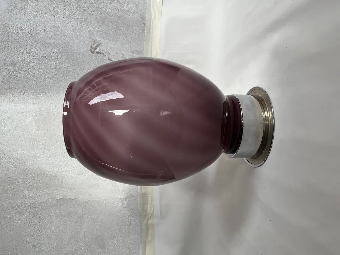 2 antique table lamps with purple shades and metal base in a neutral setting.