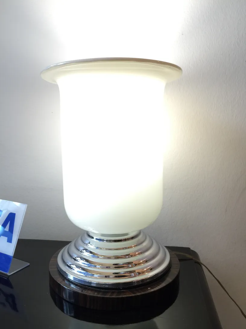 Duas lâmpadas de mesa antigas iluminando um ambiente moderno, com base redonda e cúpula branca.