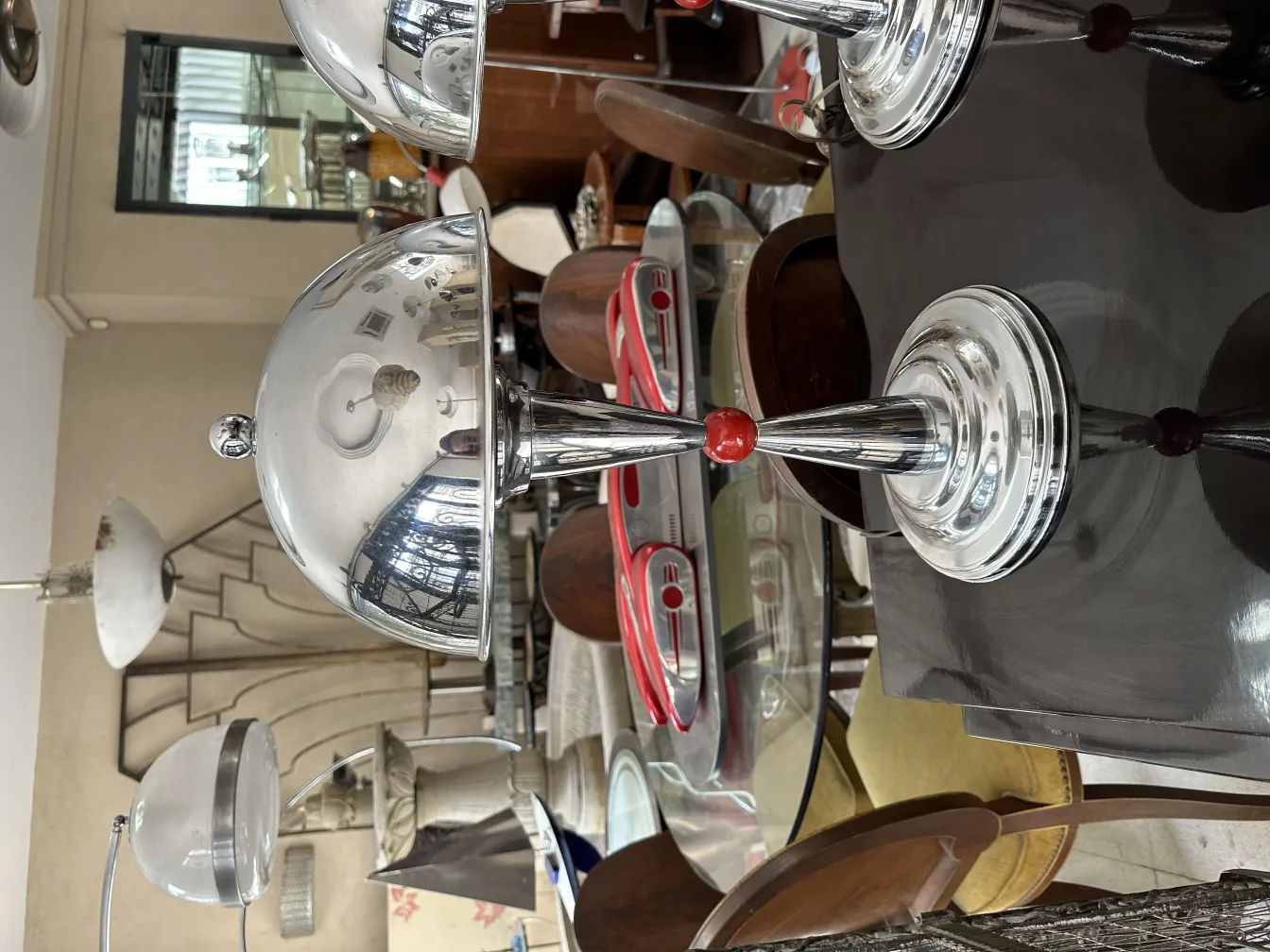 two antique table lamps with decorative details in the setting