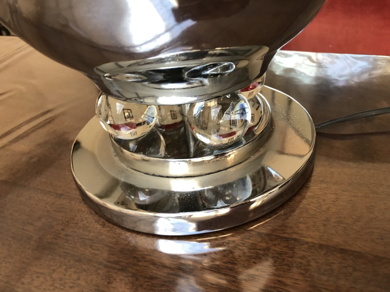 Detail of antique decorative table lamps with round base and reflective sphere.