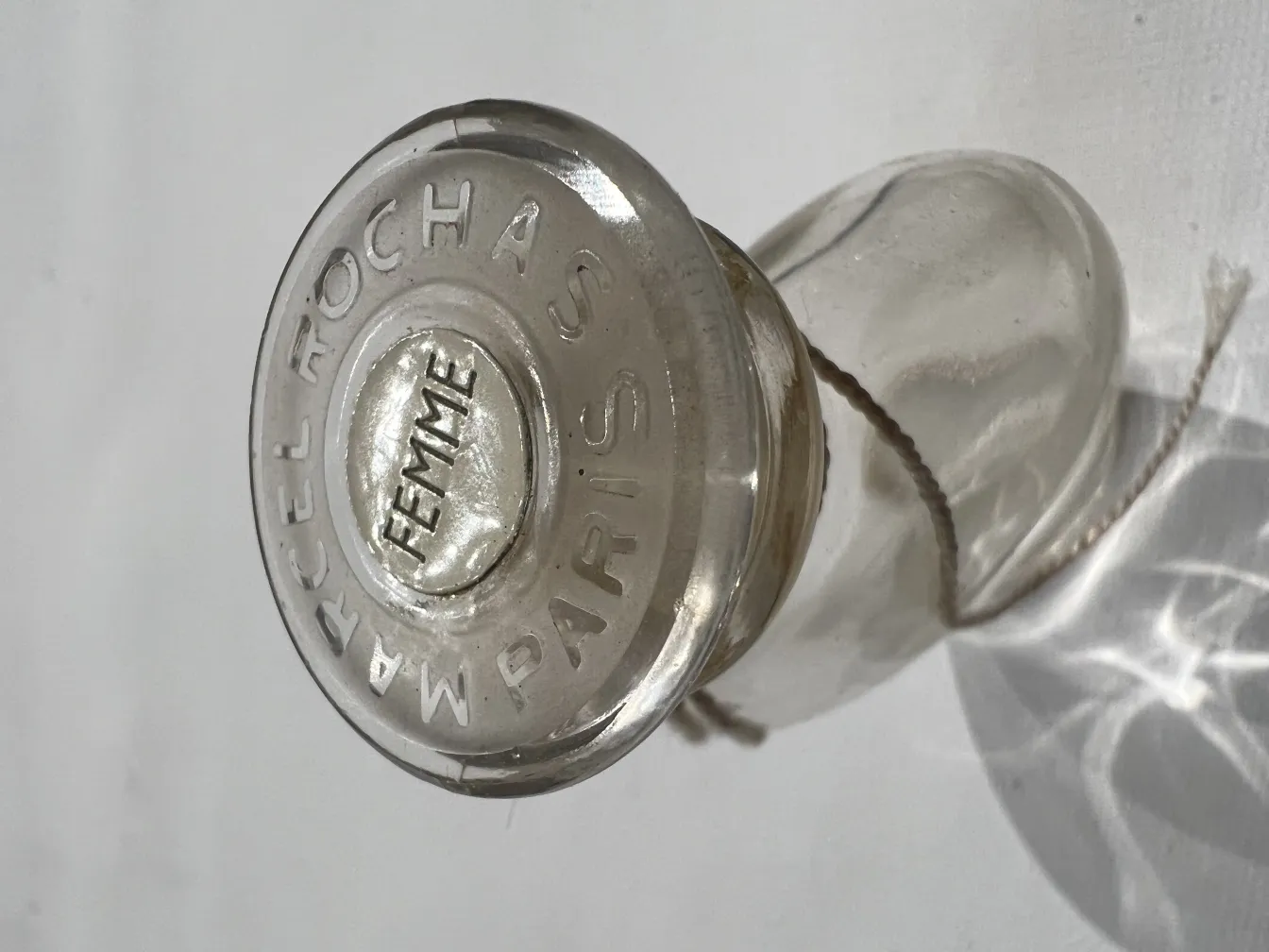 Antique perfume bottle by Marcel Rochas with classic design.