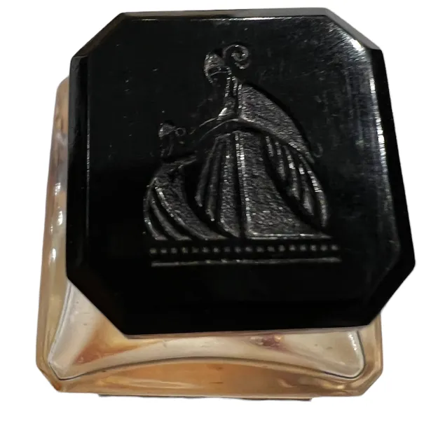 antique perfume bottle with black decorative lid in relief