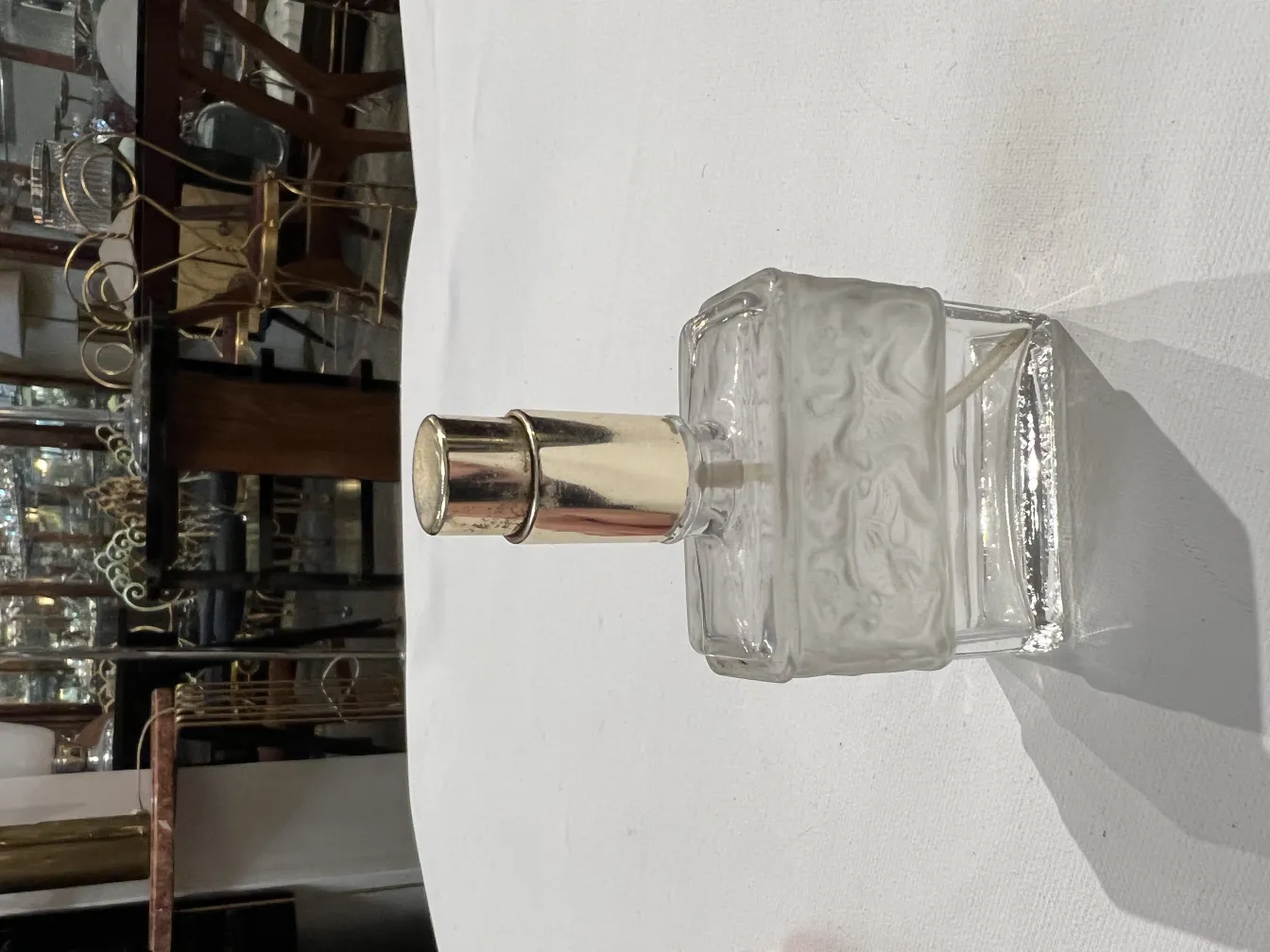 antique perfume bottle with shiny cap and intricate design