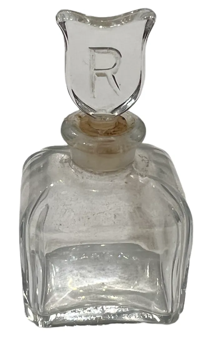 flacone di profumo antico con un bel design e tappo a scudo