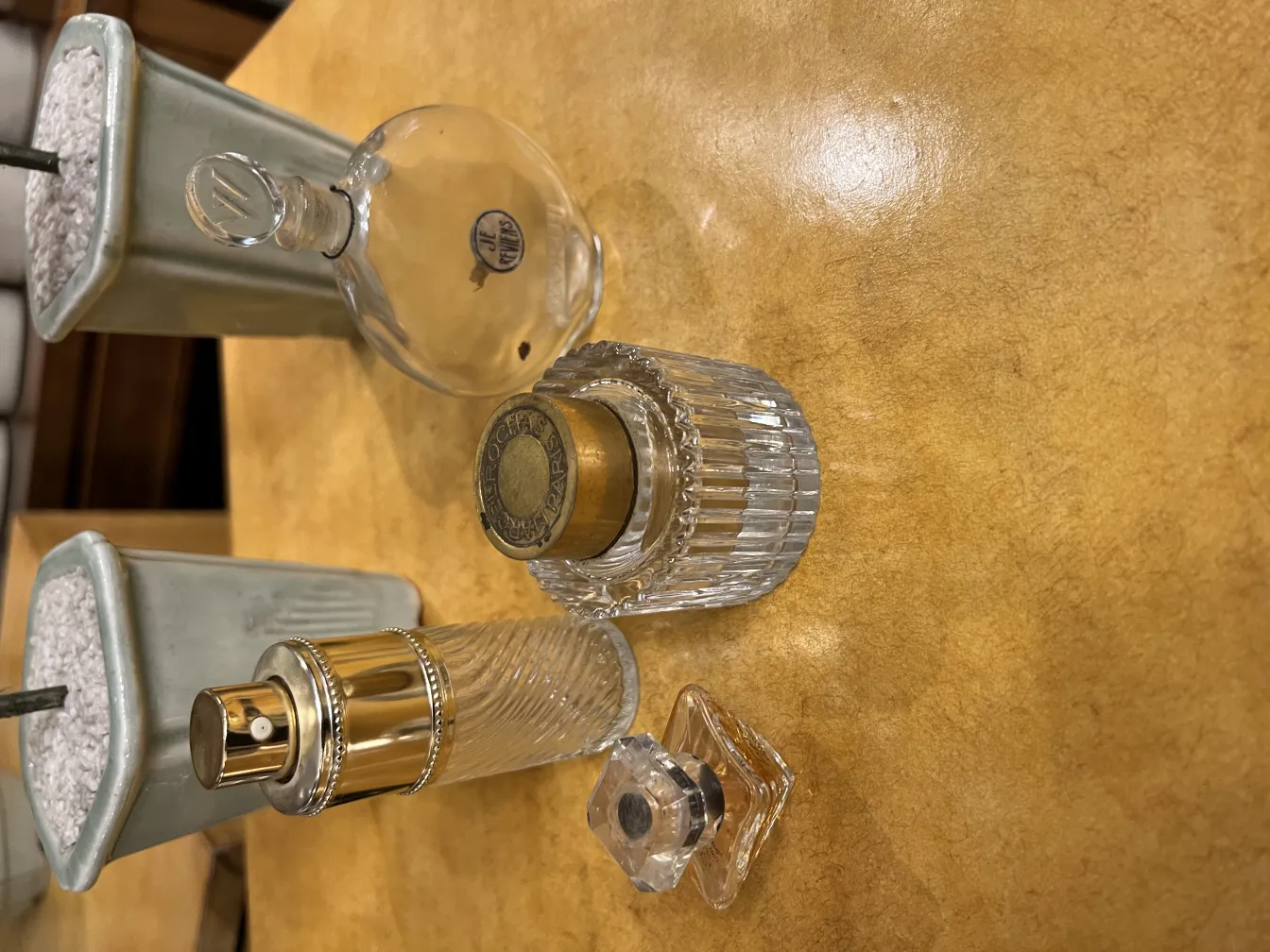 various antique perfume bottles on a table