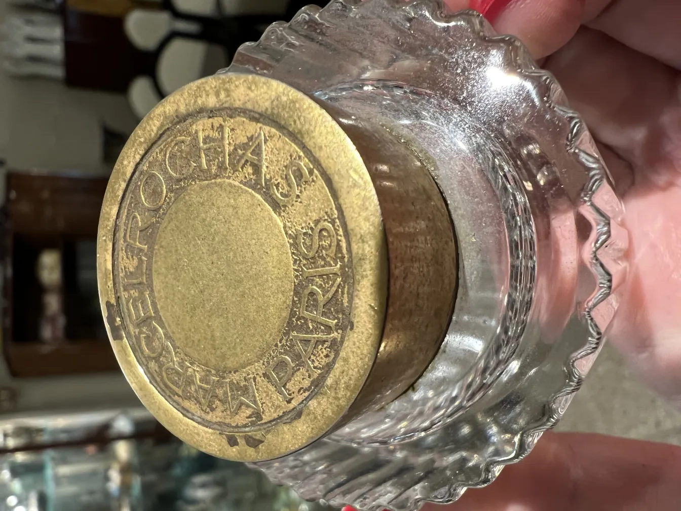 antique perfume bottle with golden lid and intricate design