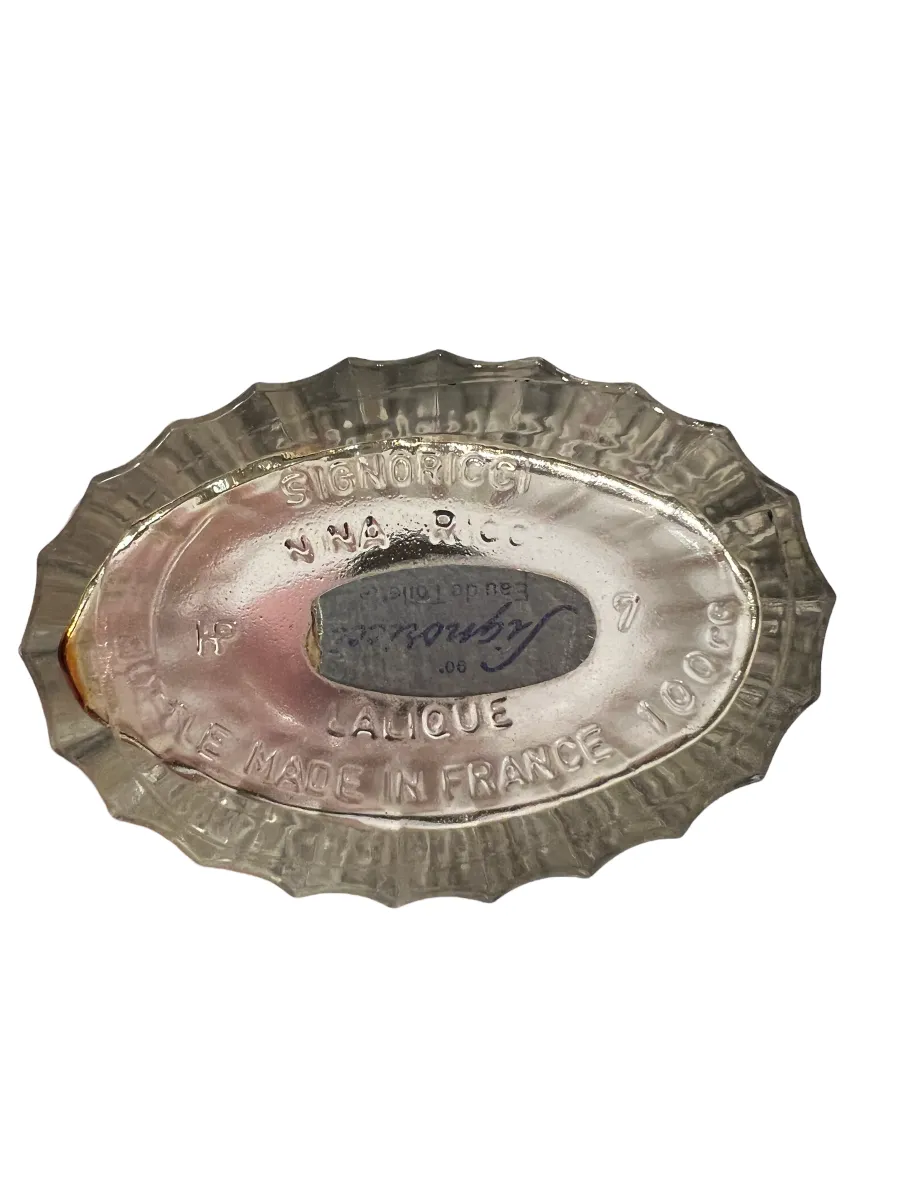 Antique perfume bottle by Lalique, elegant and detailed.