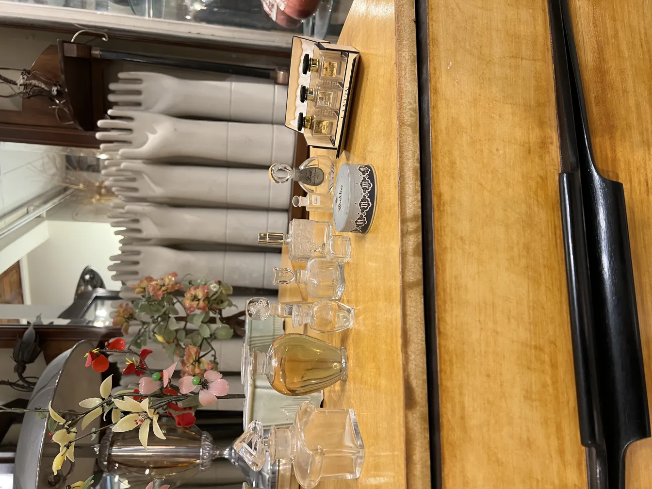 flacon de parfum ancien avec différentes tailles et formes, fleurs en arrière-plan