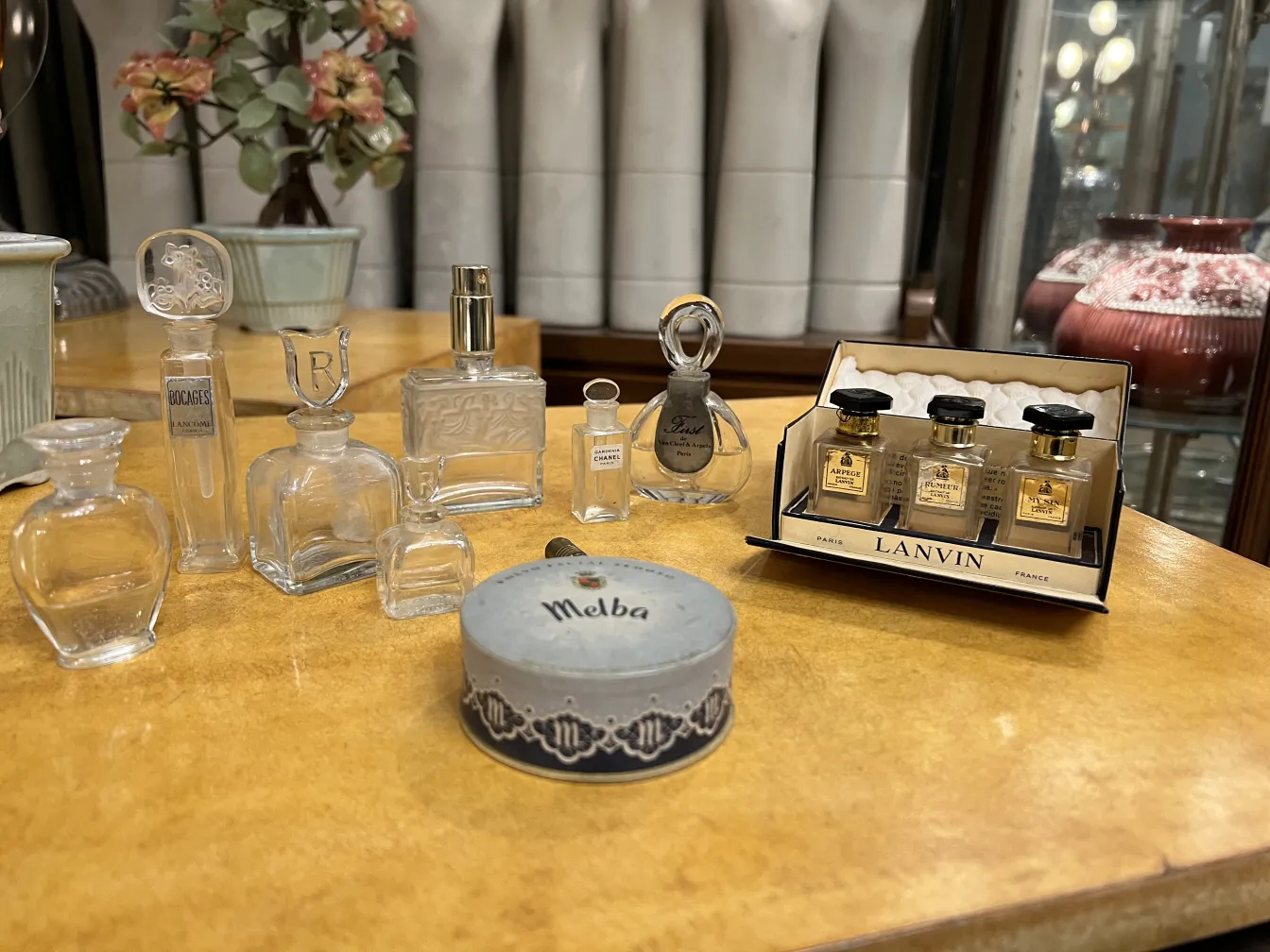 various antique perfume bottles on a wooden table, elegant display