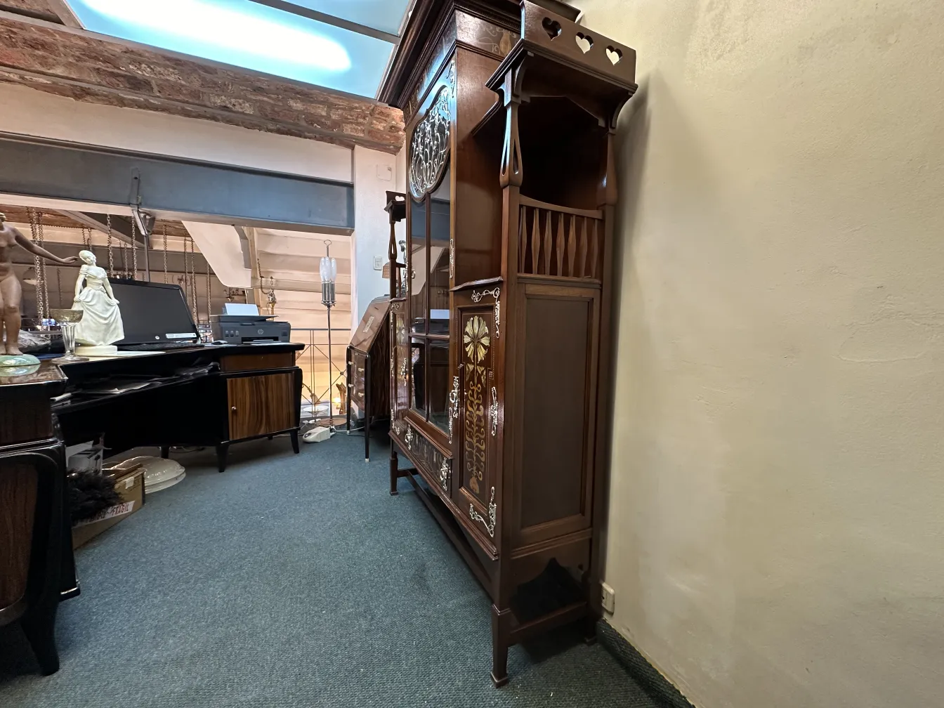 antique display cabinet shapland-petter adorned with intricate details, in a cozy setting