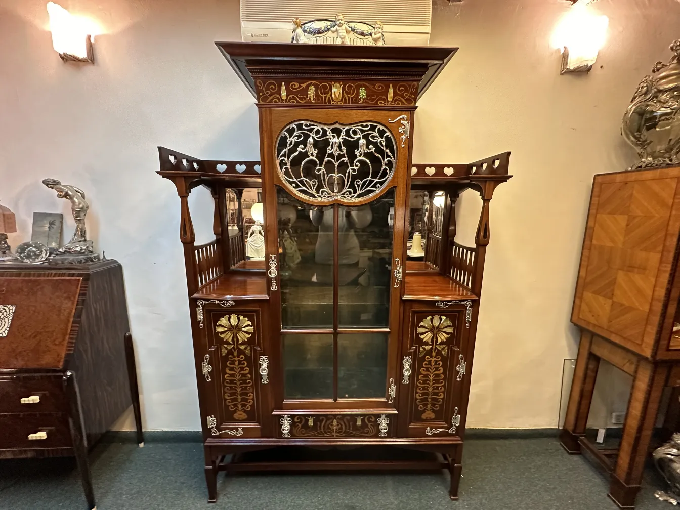 antique display cabinet with decorative details by Shapland & Petter in a classic setting