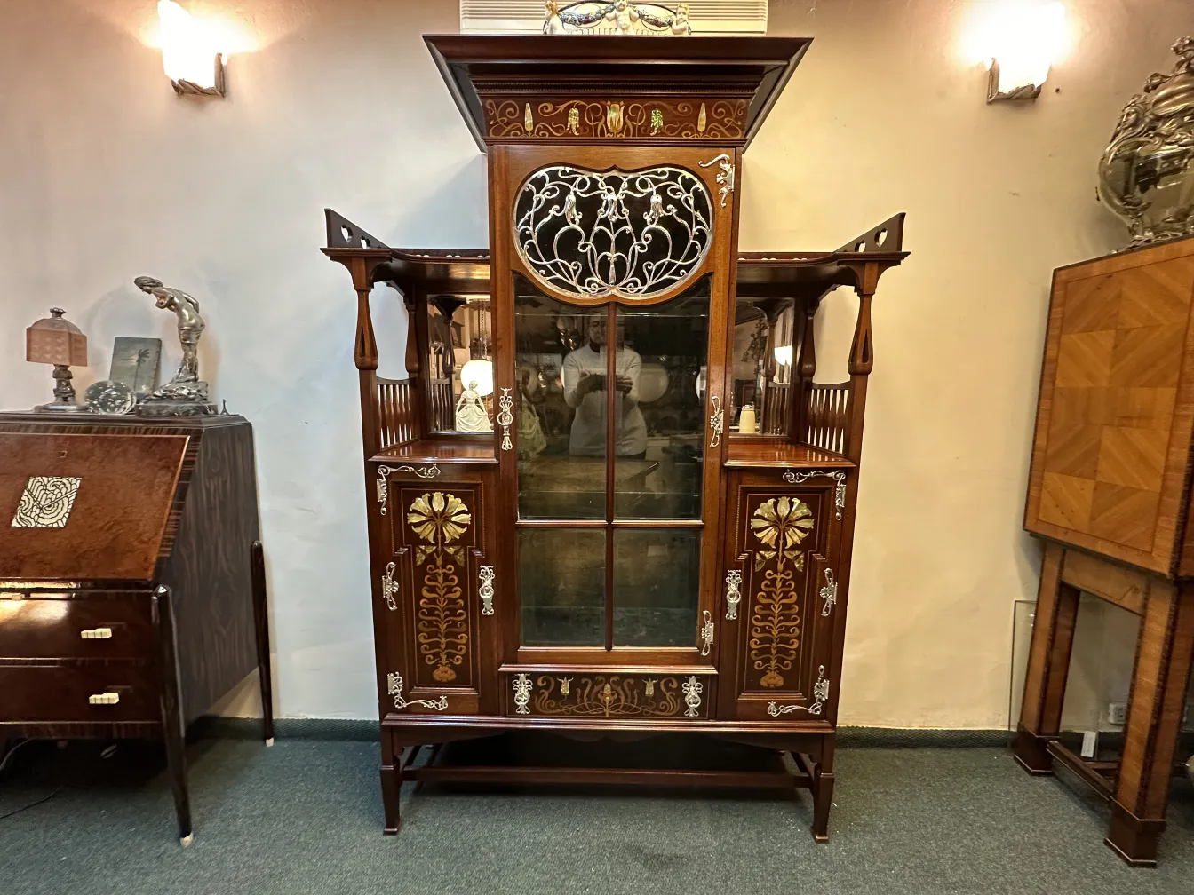 decorative antique display cabinet with elaborate details in a cozy setting