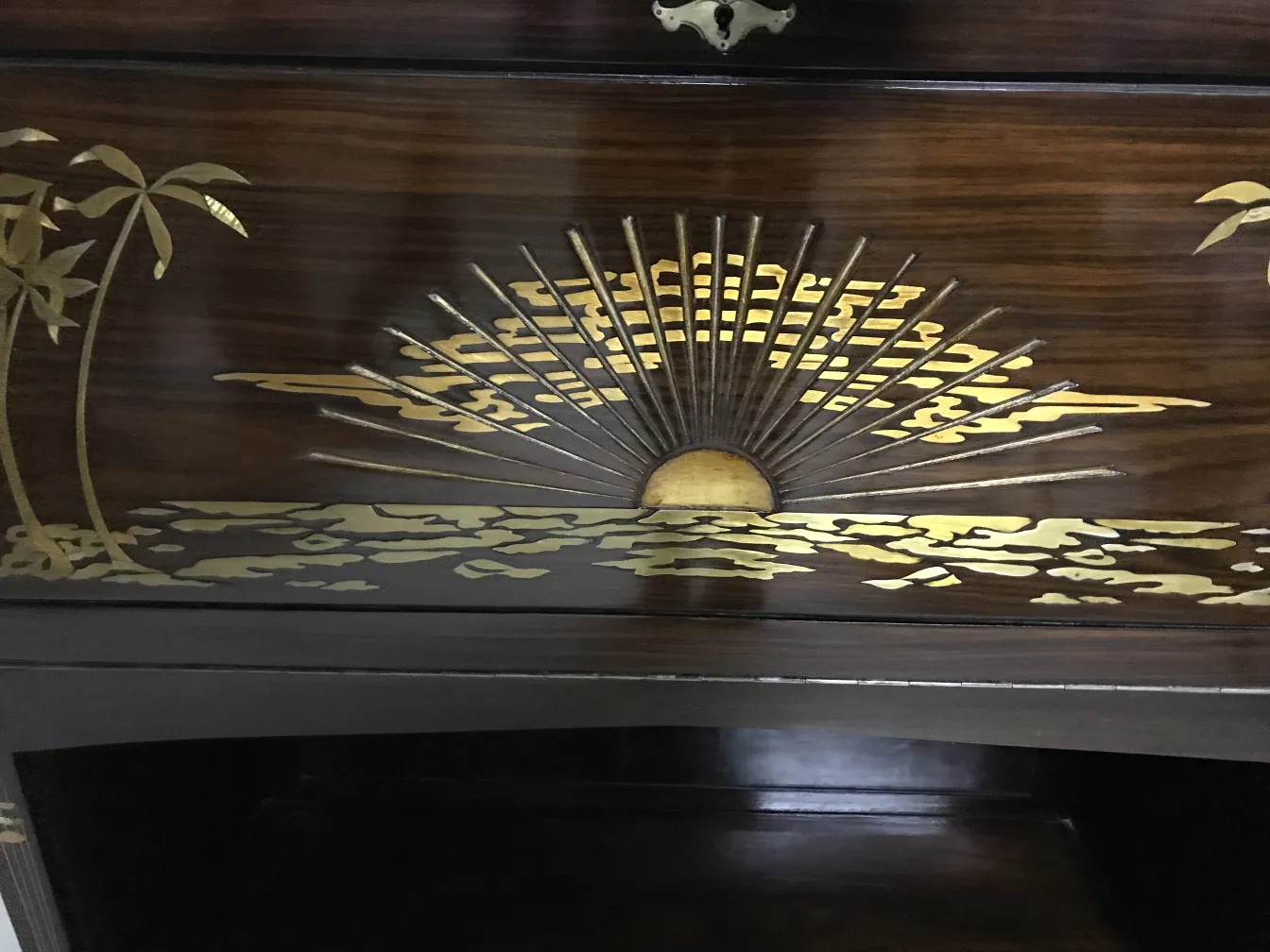 antique display cabinet with golden details and seascape