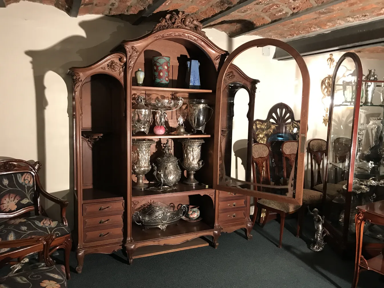 Antique display cabinet from E.Dienst - Paris showcasing beautifully arranged items.