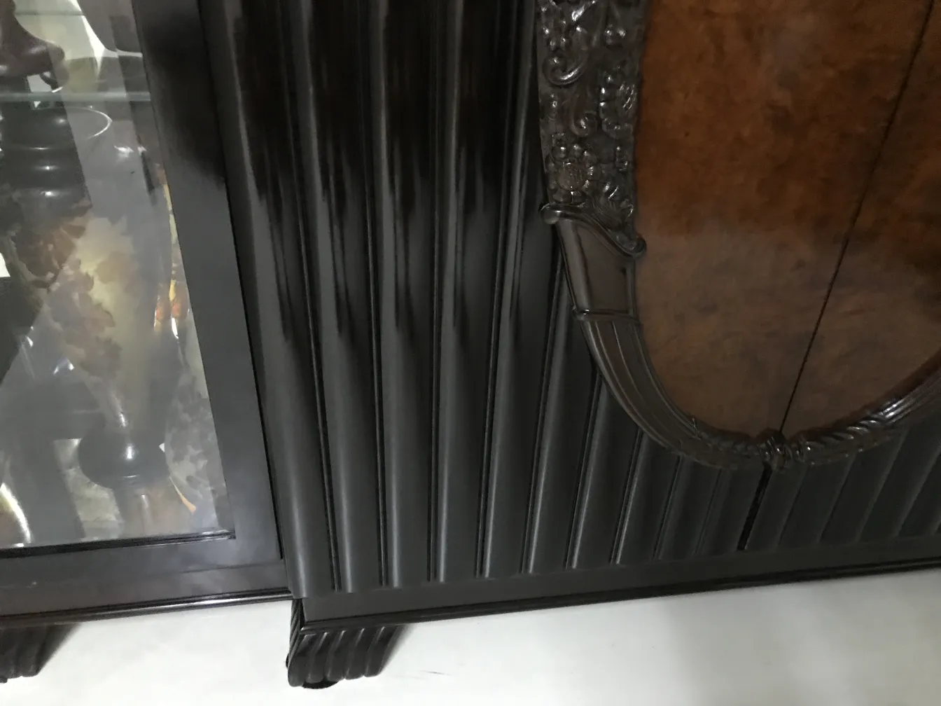 antique display cabinet with visible decorative details and a light background