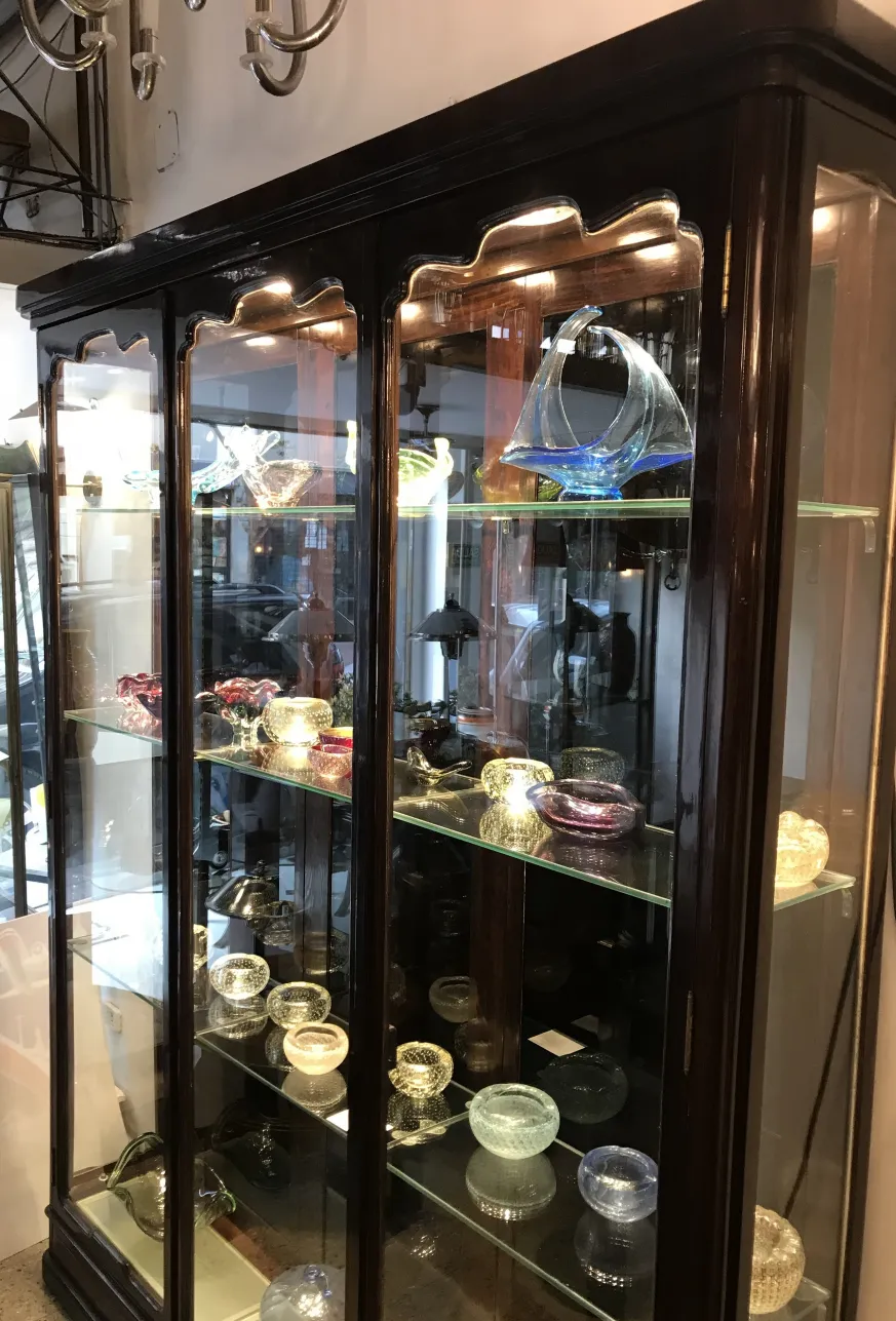 antique display cabinet with decorative glass items.