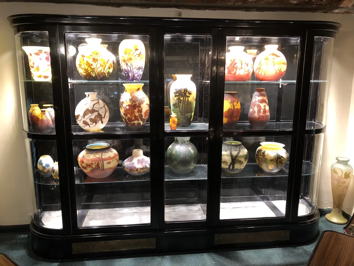 Antique display cabinet showcasing decorative and artistic items