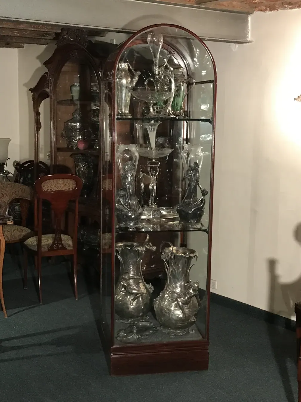 Antique display cabinet showcasing various collections, including decor and art.