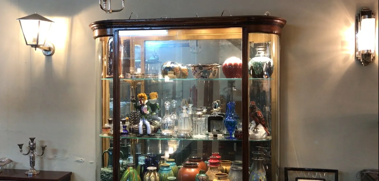 antique display cabinet with various colorful decorative items