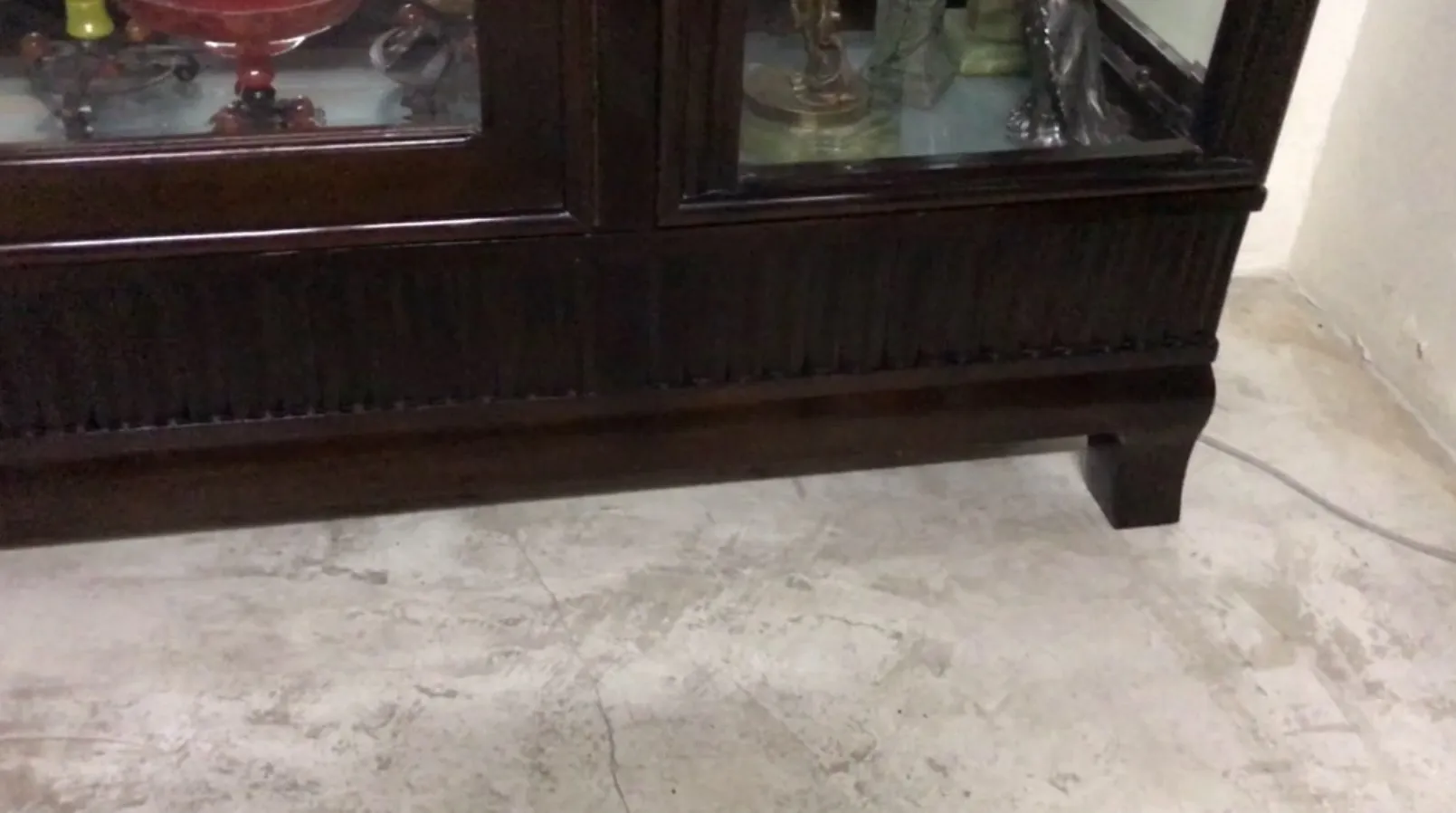 antique display cabinet with visible interior showcasing decor items
