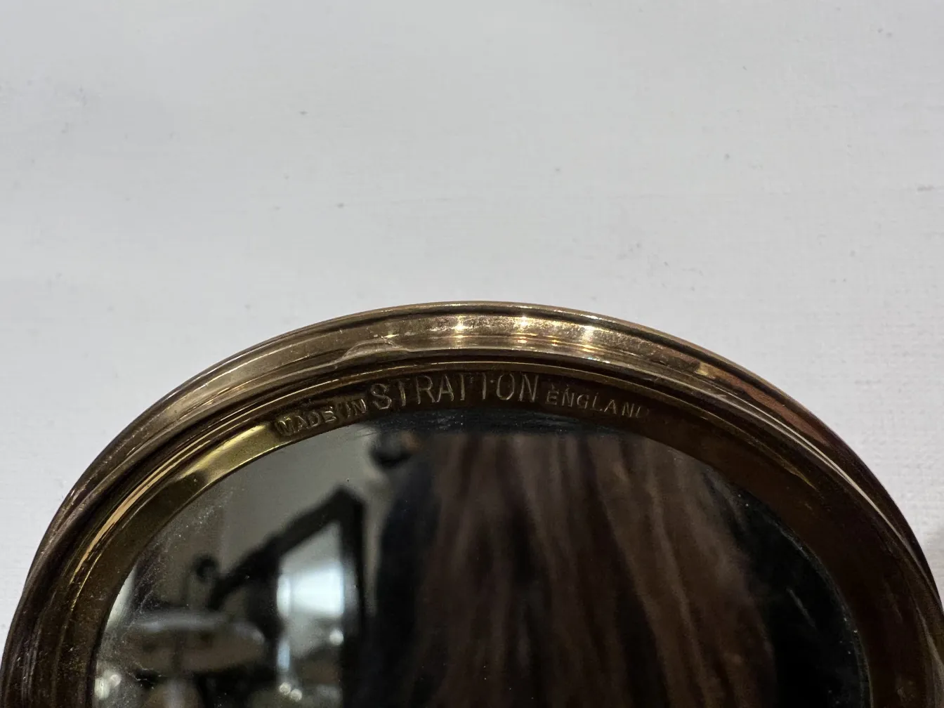 antique compact featuring a classic design with a shiny mirror