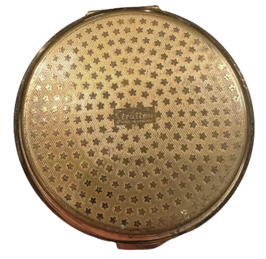 Antique compact with golden star patterns on the lid