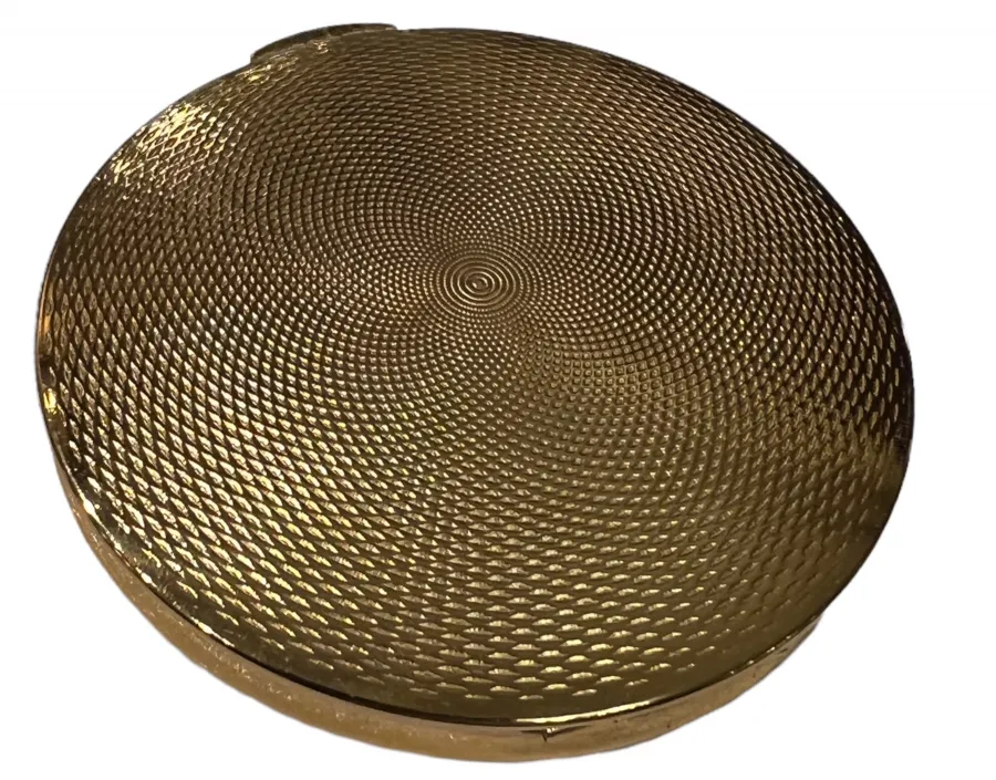 antique golden compact with embossed design