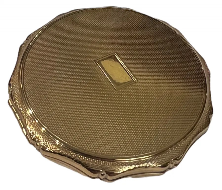 golden antique compact with textured round shape