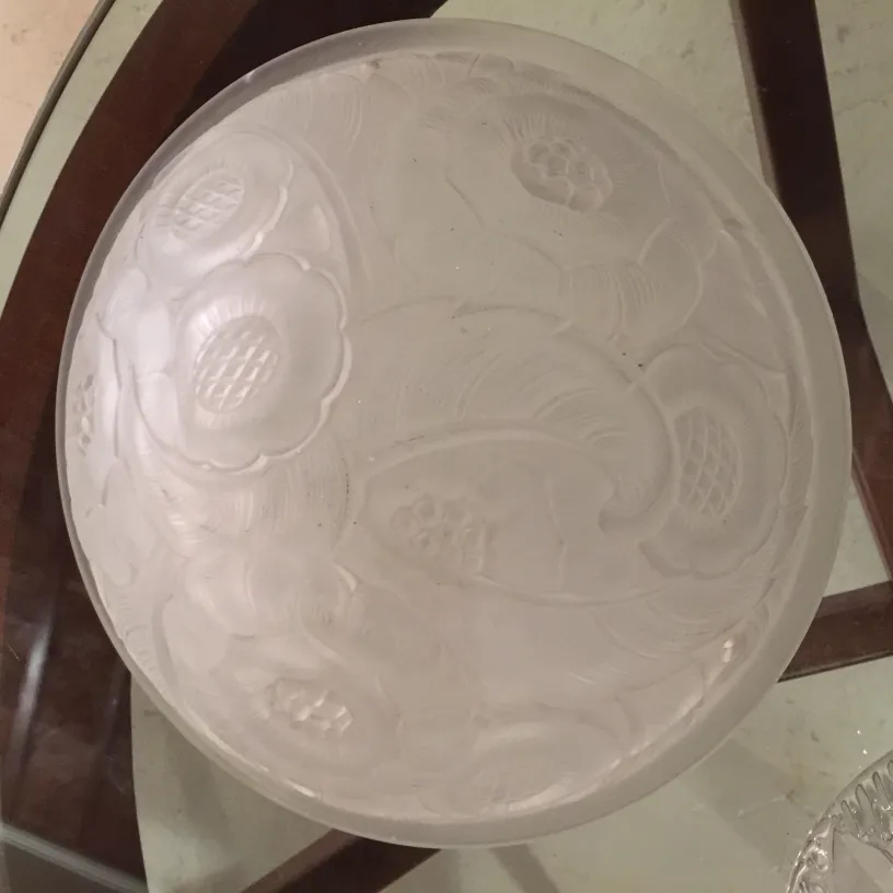 antique ceiling light with floral details, on a glass table