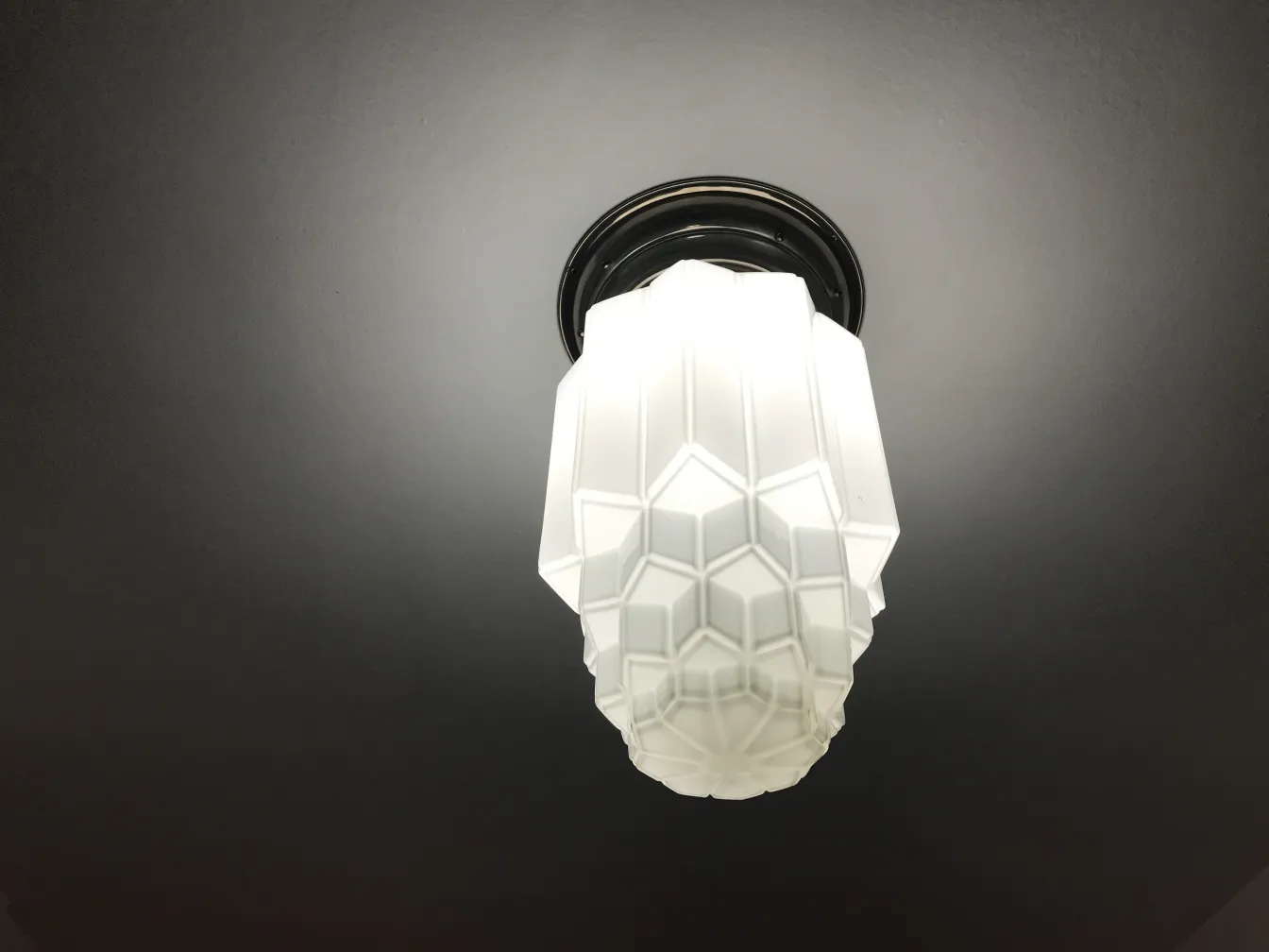 2 antique ceiling lights with geometric shape hanging from the ceiling