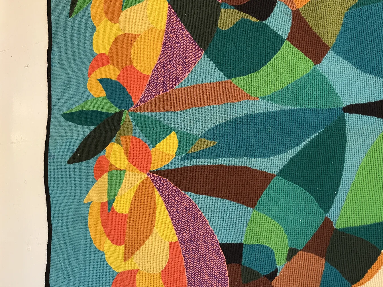 antiker bunter Wandteppich mit Blumenformen auf blauem Hintergrund