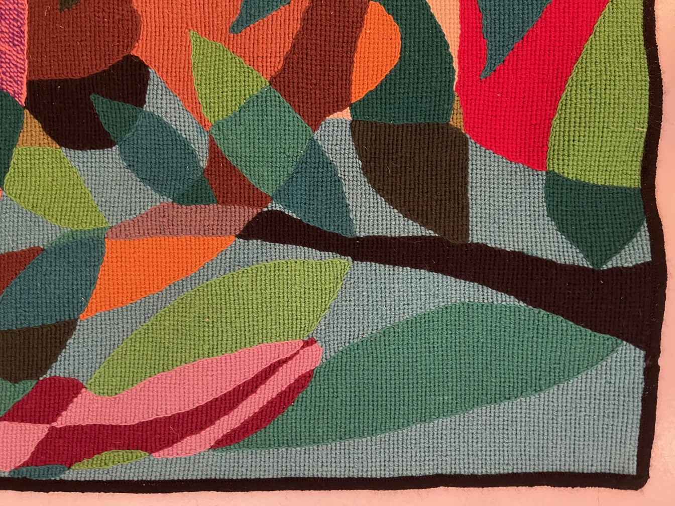 antique tapestry featuring leaves and flowers in vibrant colors