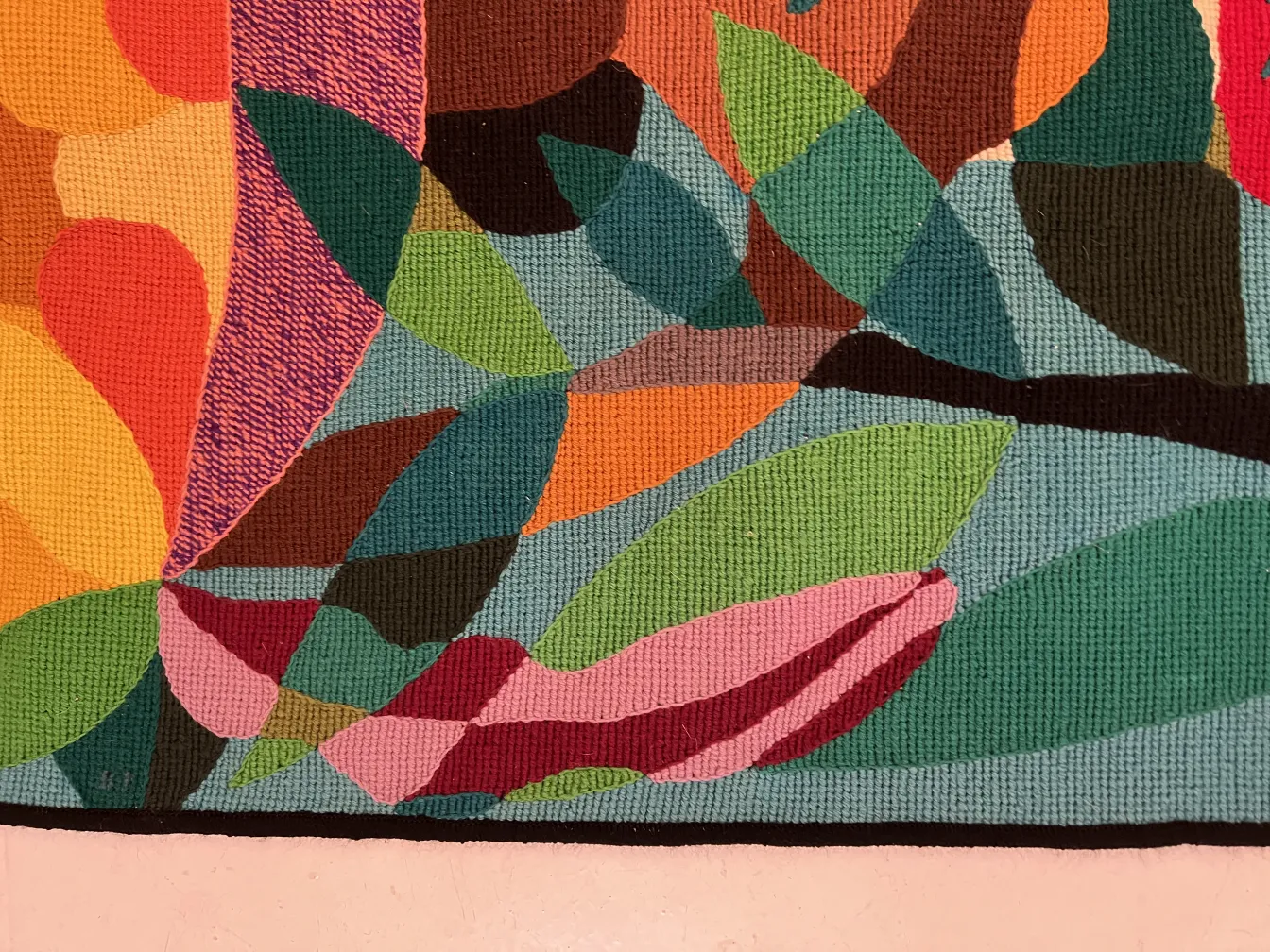 antique tapestry featuring a colorful leaf design