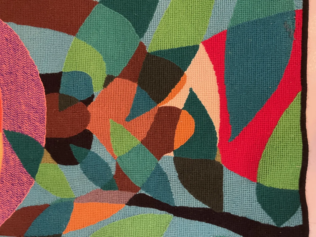 antique tapestry featuring a variety of colors and abstract shapes in a cozy setting