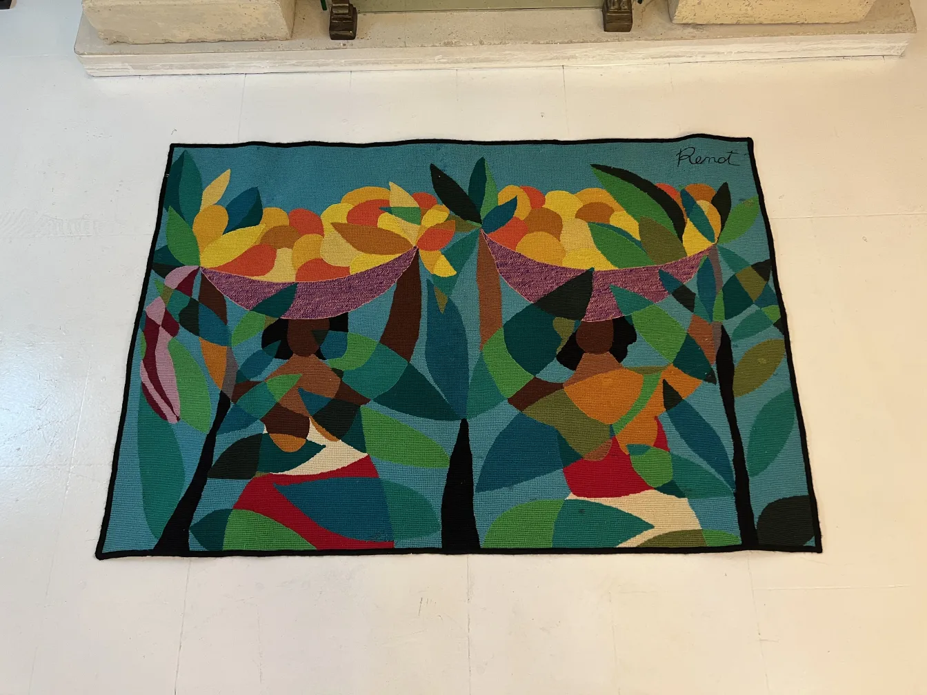 antique tapestry with abstract design of women and foliage