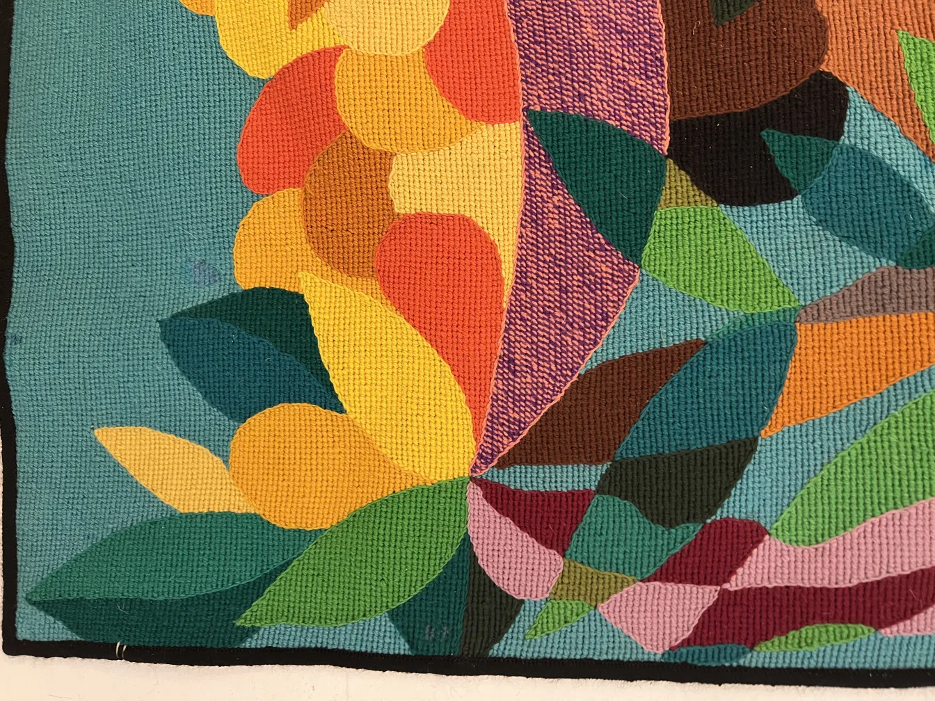 antique tapestry featuring vibrant colors and floral shapes