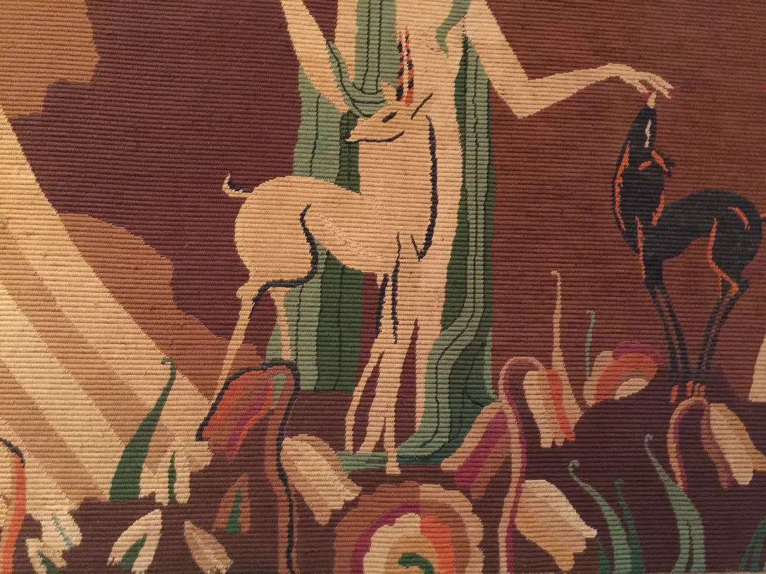 Antique tapestry featuring deer in a naturalistic style.