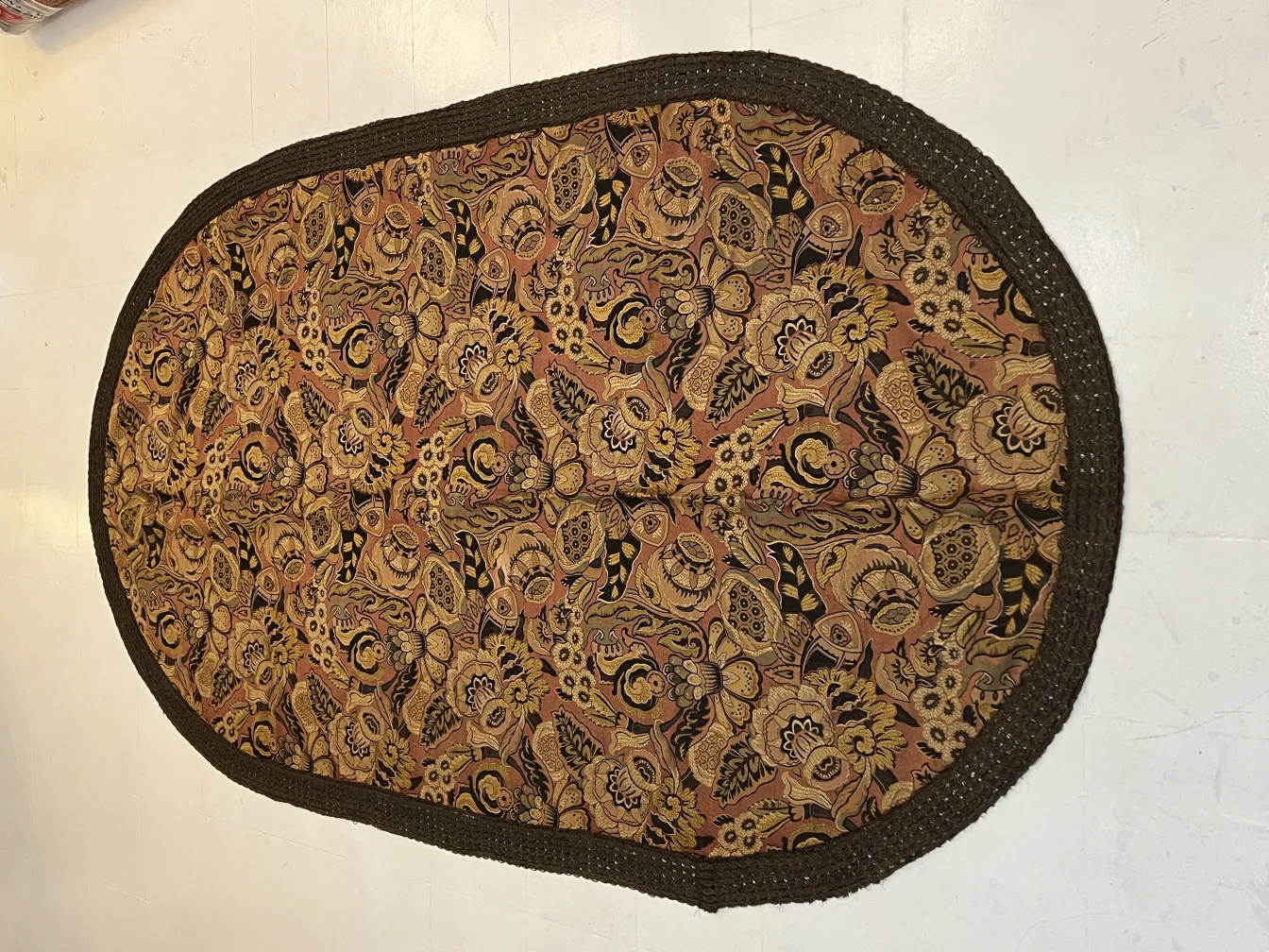 antique tablecloth featuring a vibrant floral pattern and contrasting edges