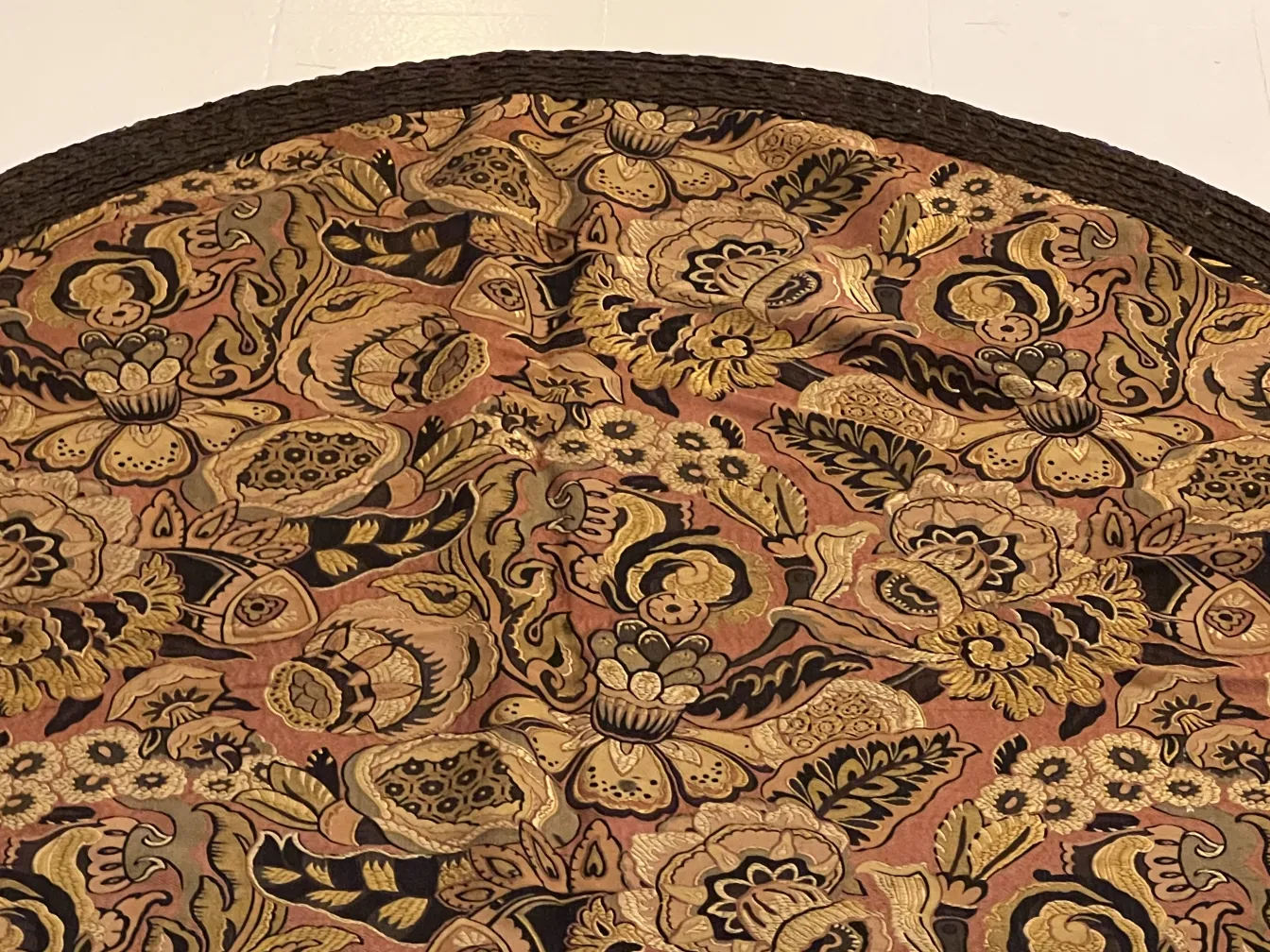 antique tablecloth with warm colors and detailed floral design