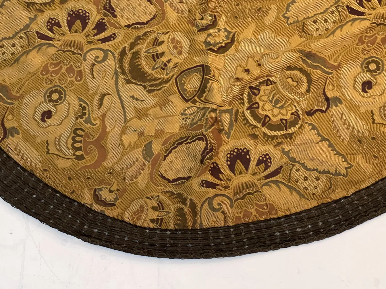 antique tablecloth with warm colored floral design