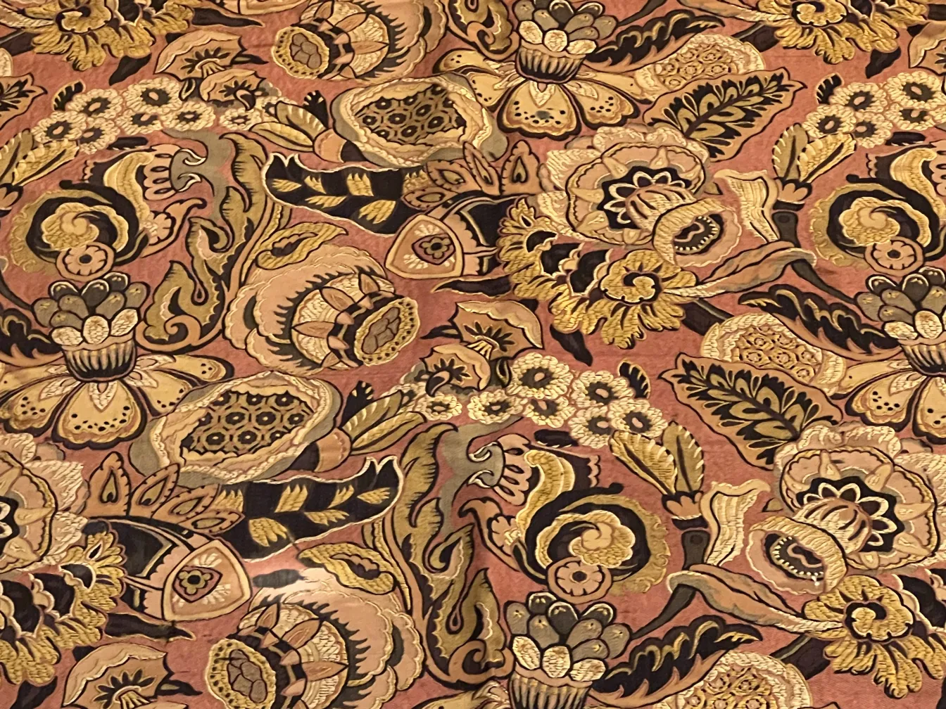 antique tablecloth with colorful floral designs on light background