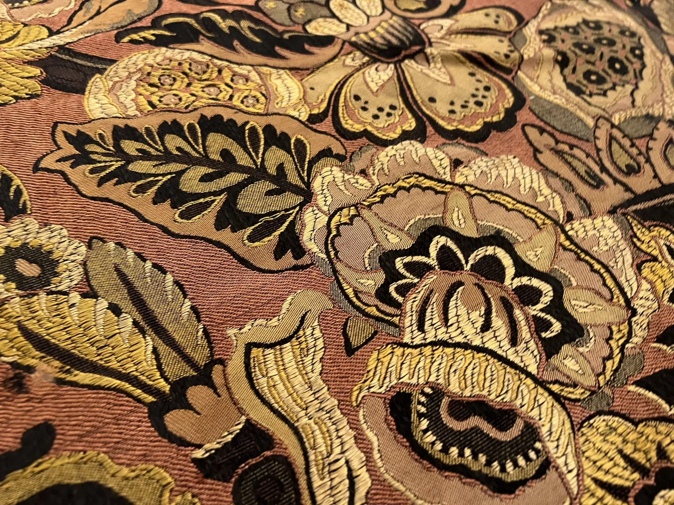 antique tablecloth decorated with flowers in various colors