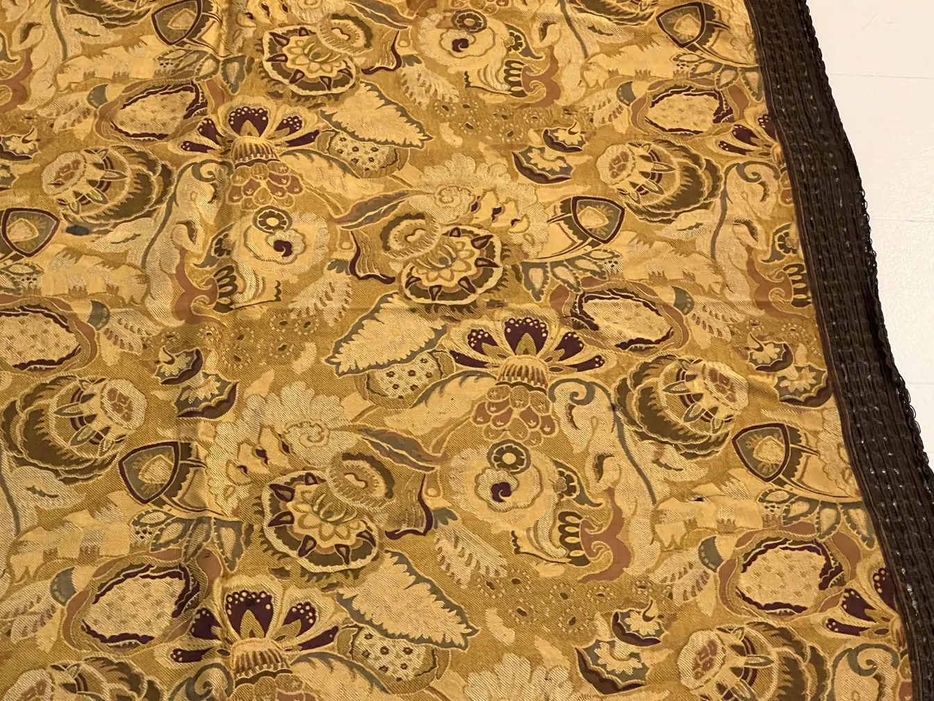 antique tablecloth with vibrant floral patterns in warm tones, creating a cozy atmosphere on the table.