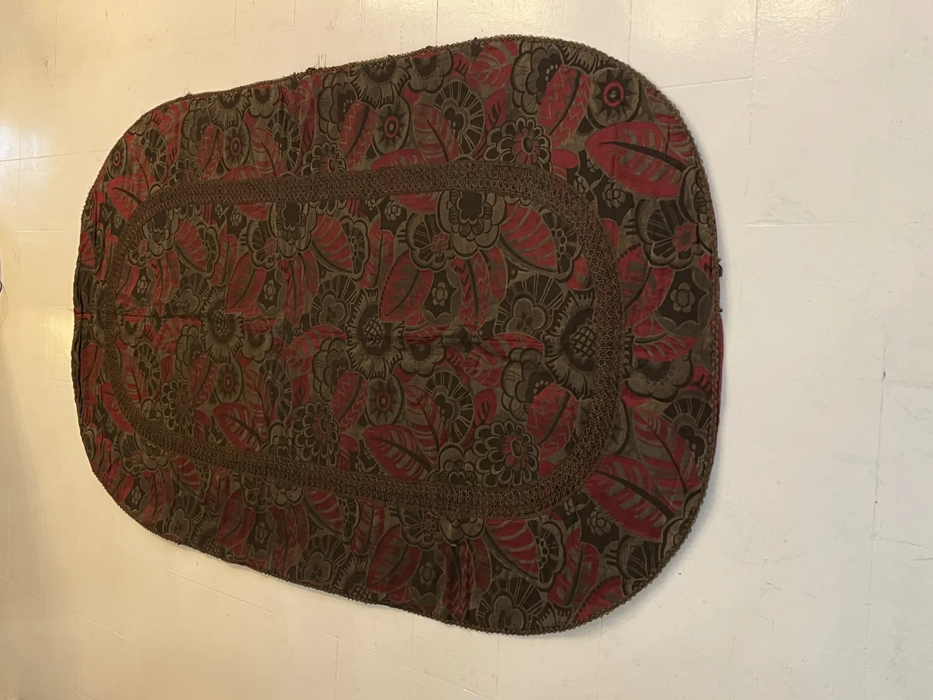 decorative antique tablecloth with floral design in brown and red tones