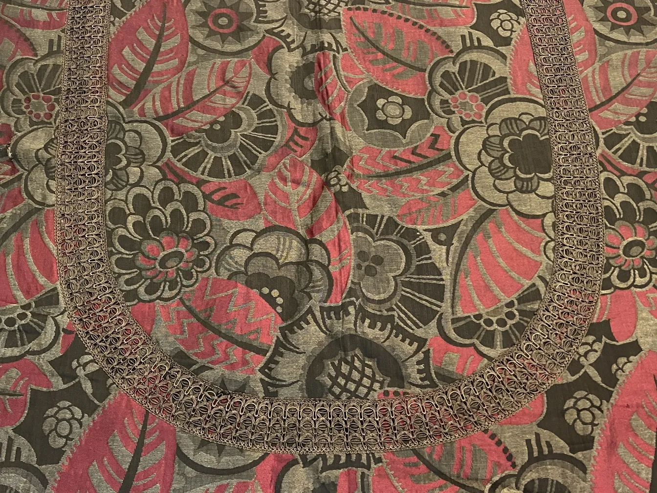 antique tablecloth decorated with floral and leaf motifs