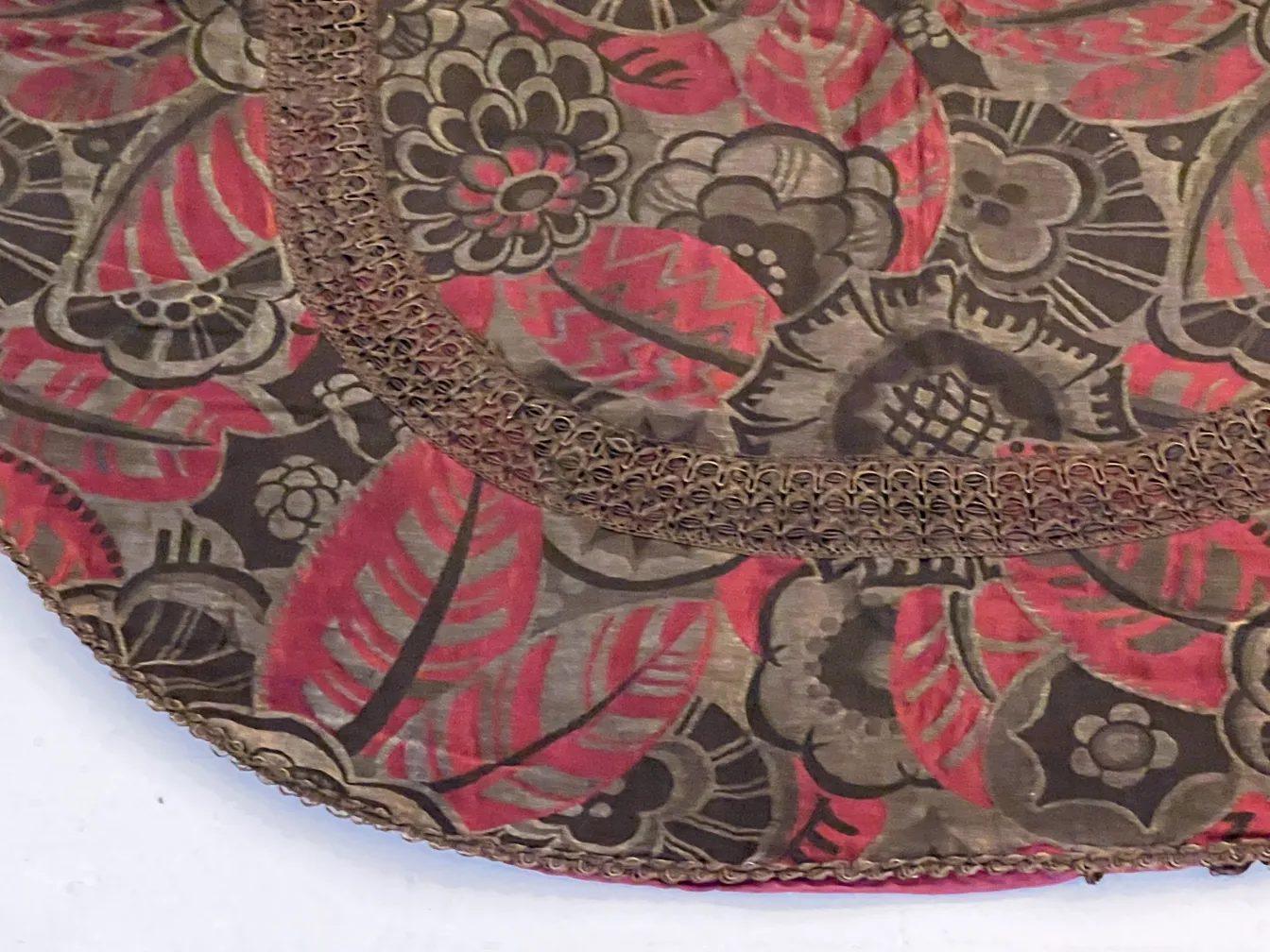 tablecloth with floral and leaf design in brown and red tones