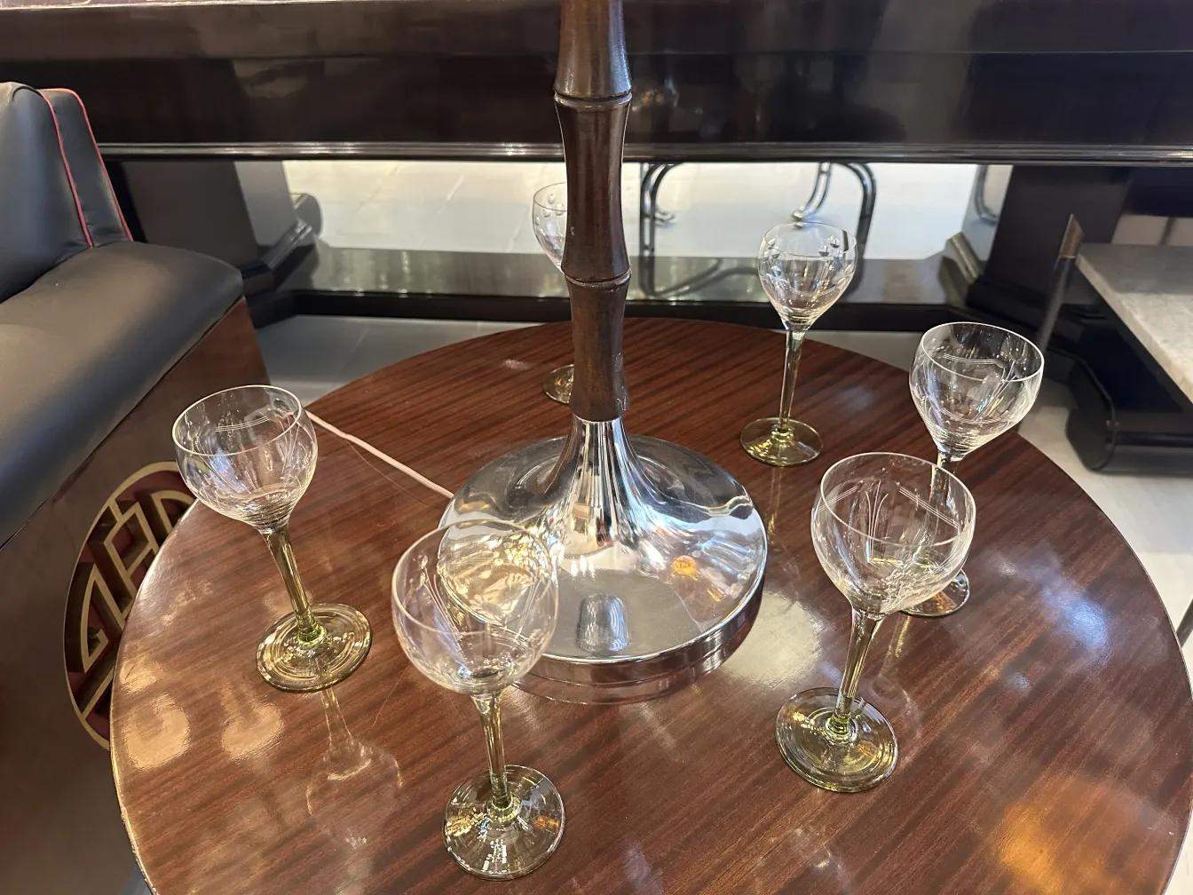 six crystal glasses with antique engraving on a shiny table