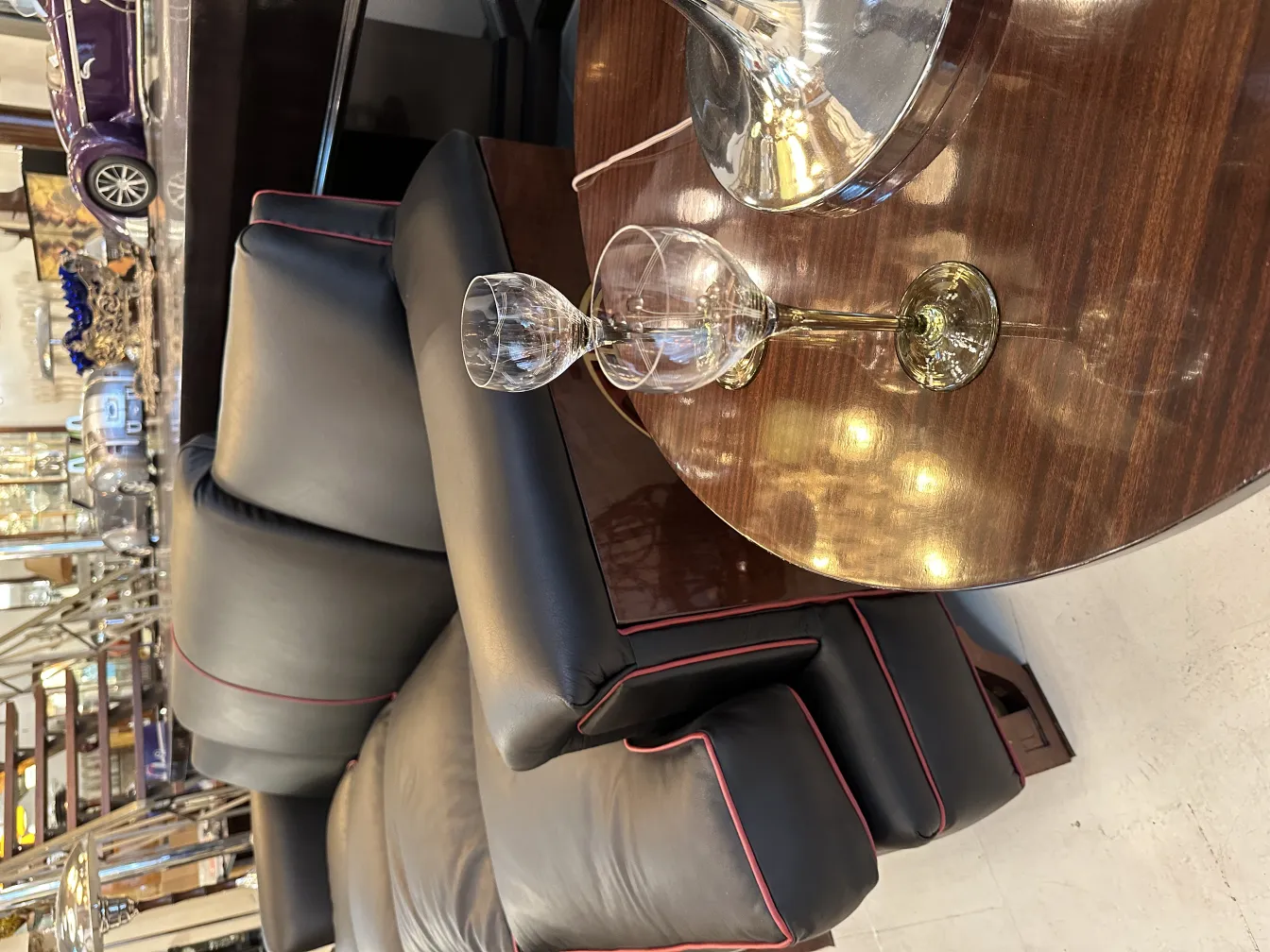 6 antique crystal glasses on a table with a sofa